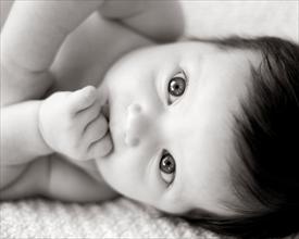Photo of a baby looking up at the camera